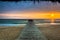 Seascape with A Pier Leading towards The Sea at Sunrise