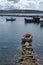 Seascape with pier, quiet sea harbor with clear transparent water and traditional greek fisher boats