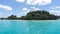 Seascape of Pines Island, new caledonia: turquoise lagoon, typical rocks, blue sky