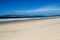 Seascape at Plettenberg South Africa showing distant people and the peninsula