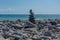 Seascape. Pyramid of stones on a rocky shore against the sea