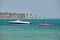 Seascape with ripple surface of blue sea water with white speedboat on anchor floating on calm waves