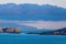 Seascape of rocky headlands, cliffs, homes and a ship along Northern Ireland`s Antrim coast