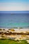 Seascape sandy beach with lighthouse on horizon