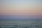 Seascape with seagull over water. Sunset over the sea. Calm evening on island beach. Tranquility concept. Dramatic evening sky.