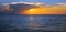 seascape with shiny sea over cloudy sky and sun during sunset in Cozumel, Mexico