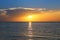 seascape with shiny sea over cloudy sky and sun during sunset in Cozumel, Mexico