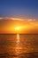 Seascape with shiny sea over cloudy sky and sun during sunset in Cozumel, Mexico