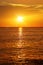 seascape with shiny sea over cloudy sky and sun during sunset in Cozumel, Mexico