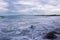 Seascape showing waves forming a mist as they splash against coastal rocks at Plum Point, Jamaica