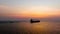 Seascape and silhouette container ship floating in sea and over the sunlight background