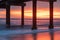 Seascape Silhouette Pier Pilings in Ocean at Sunrise