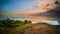 Seascape. Spectacular view from Uluwatu cliff in Bali. Sunset time. Blue hour. Ocean with motion foam waves. Cloudy sky. Nature