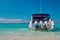 Seascape with speedboat in bay with turquoise water, blue sky. Tropical sunny landscape. Concept outdoor activities at sea.