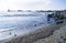 Seascape with stones. Blue sea and waves. Embankment and lighthouse.