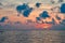 Seascape summer sunset at sea. Clouds over sea in orange light Evening sun. Loneliness landscape.