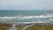 Seascape on a sunny day. A glaring ocean surface with sailboats on the horizon.