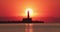 Seascape of sunrise over sea lighthouse and coastal beach shore, silhouette of beacon and seashore , Varna Bulgaria