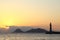 Seascape at sunset. Lighthouse on the coast. Seaside town of Turgutreis and spectacular sunsets