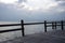 Seascape sunset skyline behind wooden pier fence