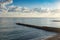 Seascape with a view of the breakwater and the fisherman