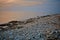 Seascape view. Rocky beach in evening. Pebble shore. Tinted photo