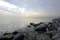 Seascape view from the shore with large mossy stones.