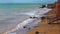 Seascape, waves from muddy salty water on the beach in the Black Sea, wave reflections on the surface of the water, Black Sea