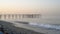 Seascape waves pier at sunrise