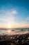 Seascape. Wild pebble beach at sunset