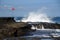 Seascapes at the south coast in Bali island of Indonesia,with rock formation,black sand and wave during day time