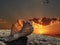 Seashell on rock stone at evening golden sunset cloudy sky  wild nature landscape  background