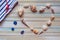 Seashells shaped heart on a wooden background top view