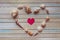 Seashells shaped heart on a wooden background top view