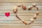 Seashells shaped heart on a wooden background top view