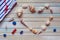 Seashells shaped heart on a wooden background top view