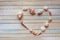 Seashells shaped heart on a wooden background top view