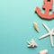 Seashells and starfish and anchor on emerald green background