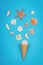 Seashells and starfish and ice cream cone on blue background. Summer concept