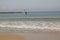 seashore beach, sand, water waves, blue sky