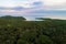 Seashore blue ocean with green tree forest