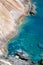 Seashore coastline with cliff and rocks on a mountain slope. Blue sea of the Island of Elba in Italy in the Tuscany region.