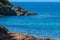 Seashore coastline with cliff and rocks on a mountain slope. Blue sea of the Island of Elba in Italy in the Tuscany region.