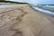 Seashore after rain, wet sea sand, deserted sea beach