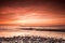 seashore with red colours at dusk