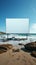 Seashore statement Unfilled billboard contrasting with sea expanse on sandy beach