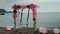 On the seashore swing empty swings decorated with flowers and balls.