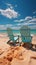 Seashore tranquility Beach chairs on white sand under blue sky and sunny glow