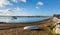 Seashore and view towards Poole harbour and quay Dorset England UK with sea and sand on a beautiful day