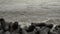 Seashore waves striking hard on black rocks at Queens necklace marine drive beach Mumbai, India